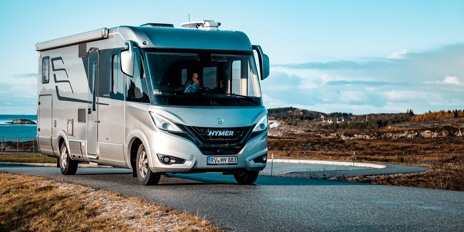 Driving HYMER B-Class MasterLine I in a Scandinavian coastal landscape with sea and blue sky
