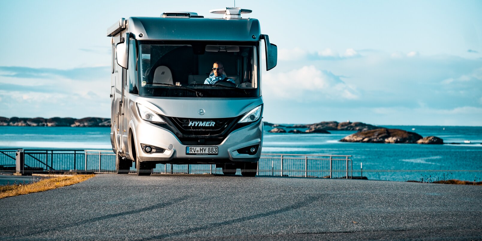 Parked Hymermobil B-Class MasterLine I in a Scandinavian coastal landscape with small rocks in the water