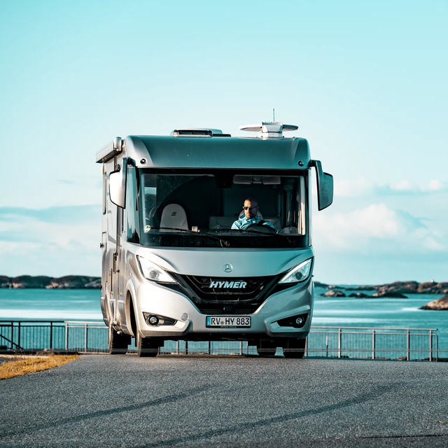 Parked Hymermobil B-Class MasterLine I in a Scandinavian coastal landscape with small rocks in the water