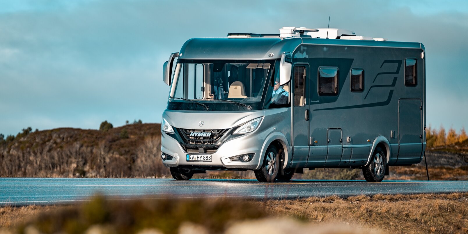 Mercedes based HYMER B-Class MasterLine on the road in the middle of a Scandinavian landscape