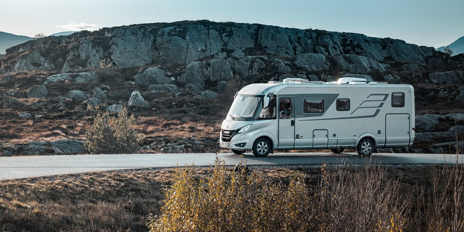 HYMER B-Class MasterLine from the side on a road in Scandinavia with a typical hilly landscape
