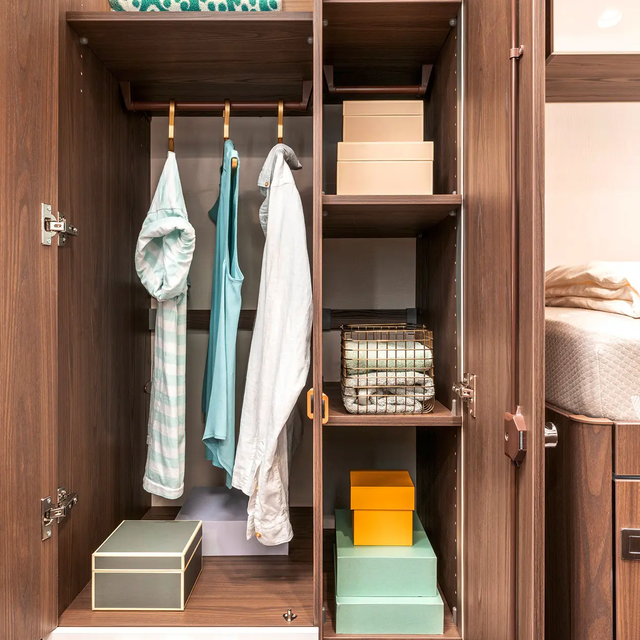 Illuminated two-door wardrobe with two drawers, several shelves and clothes rail in the HYMER B-MasterLine