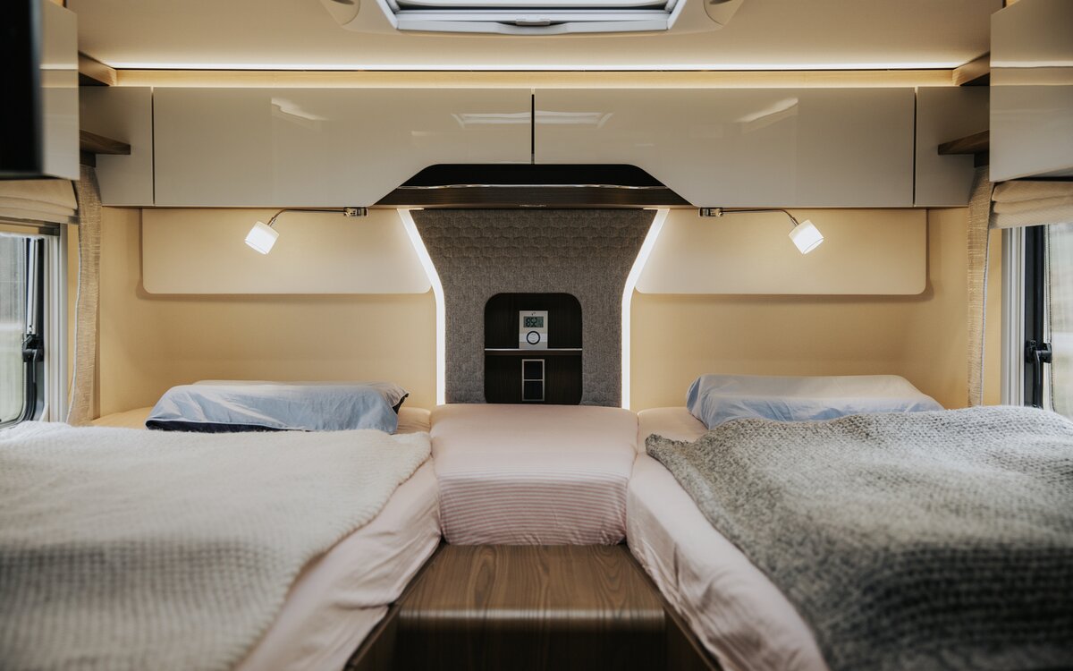 Bedroom with central entry to the twin beds in the rear of the HYMER B-Class MasterLine