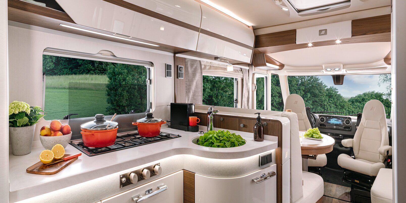Bright kitchen work surface with 3-burner stove and cooking utensils in the HYMER-B MasterLine