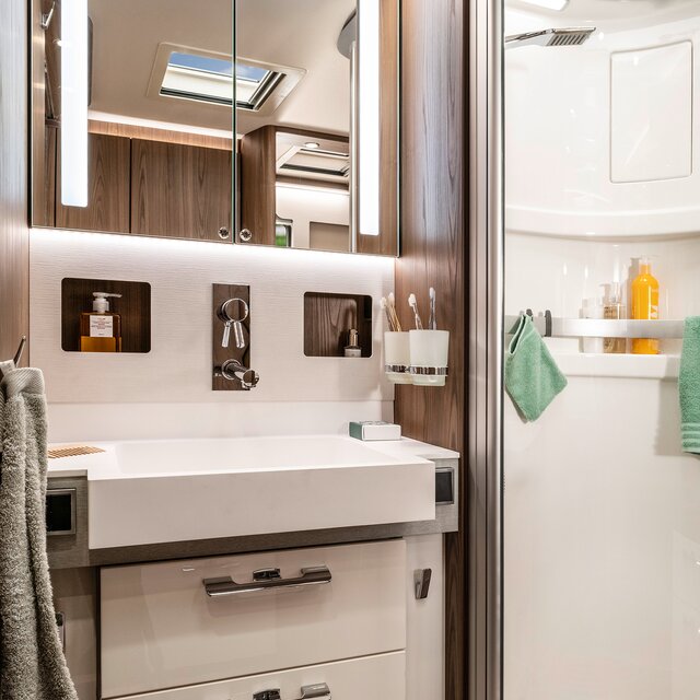 Bathroom in the HYMER B-Class MasterLine with indirectly lit mirror cabinet and drawers under the washbasin