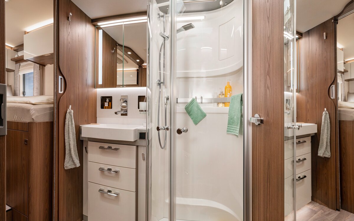 Bathroom in the HYMER B-ML I 880: mirror cabinet, drawers under the washbasin, separate shower with real glass doors, bathroom accessories