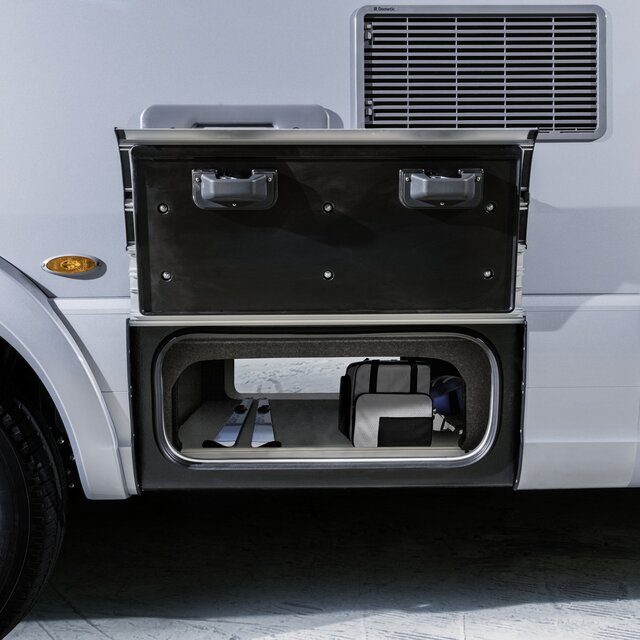 Through-loading compartment open on both sides, loaded with a pair of skis and bags in the HYMER B-MasterLine with SLC chassis