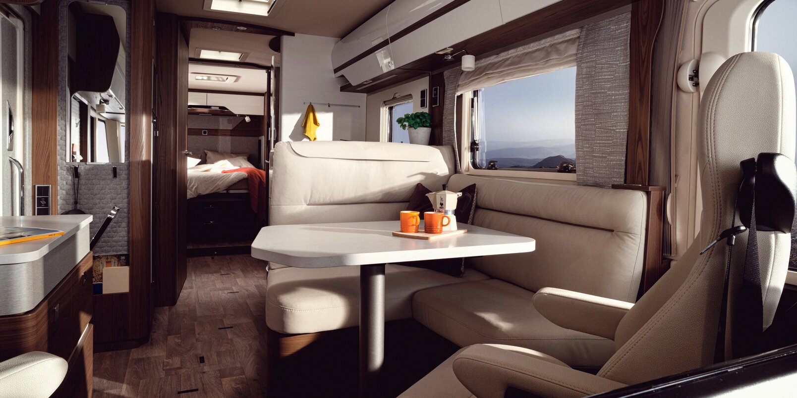 Cream-colored leather L-shaped seating group including both driver's seats in the HYMER B-MasterLine