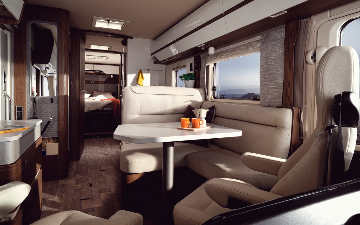 Cream-colored leather L-shaped seating group including both driver's seats in the HYMER B-MasterLine