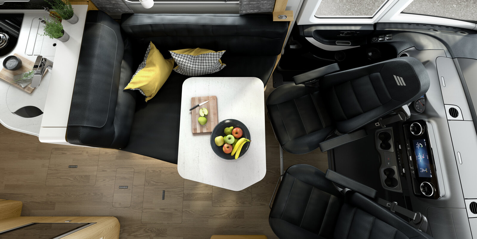 Dinette incl. sedili cabina guida in stile pelle nero dell’HYMER MasterLine, sul tavolo apparecchiato si trova un piatto con frutta