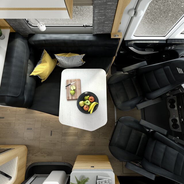 Black leather seating group including driver's seats and table with fruit bowl in the HYMER MasterLine
