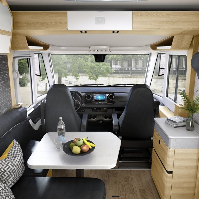 Decorated living area in the HYMER B-Class MasterLine motorhome with black seating area and light-colored furniture