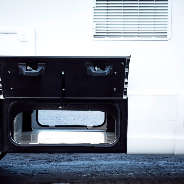 Bright kitchen with hob and coffee maker with a view of the sleeping area in the rear of the HYMER B-ML T