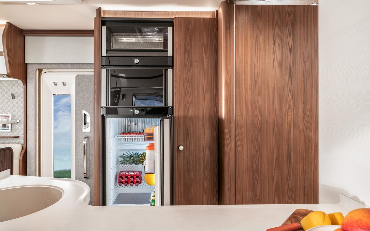 Open refrigerator, oven and entrance door in the HYMER B-Class MasterLine