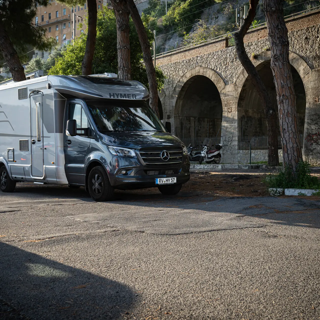 HYMER B ML-T 780 parked in the shade of plane trees and an aqueduct in southern France