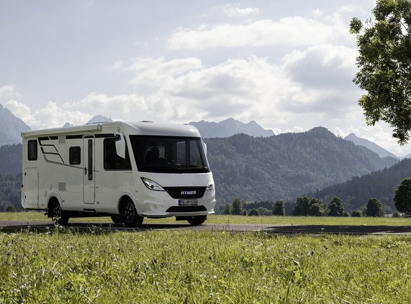 HYMER Exsis-i 580 on the shores of the troubled cold sea and snow-capped mountains