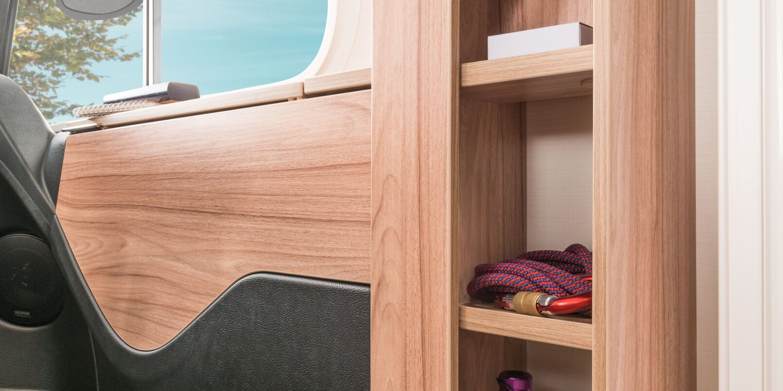 Shelf compartments in the entrance area of the HYMER Exsis-i motorhome for storing utensils