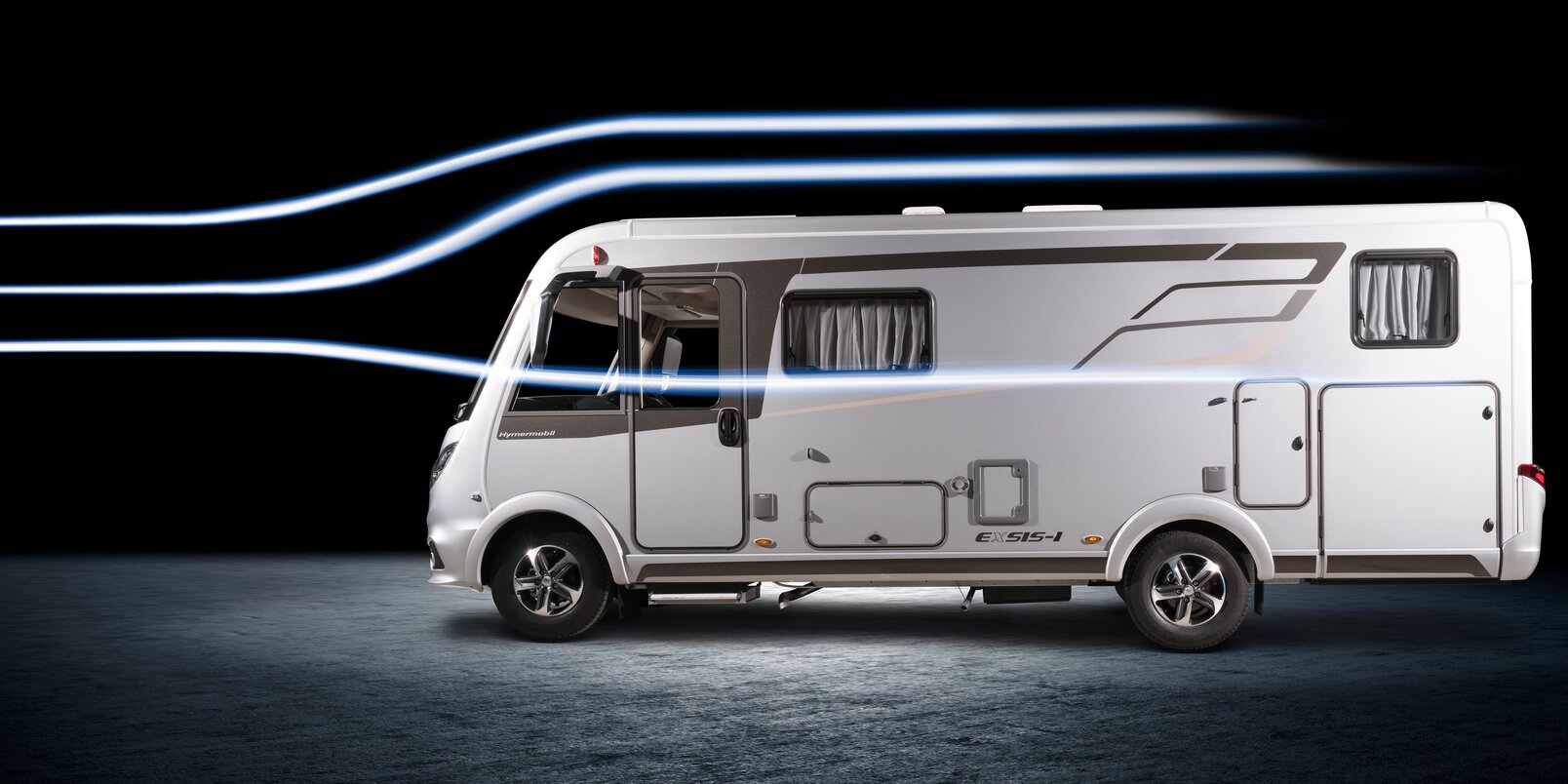 Side view of the HYMER Exsis-i motorhome in the headlights