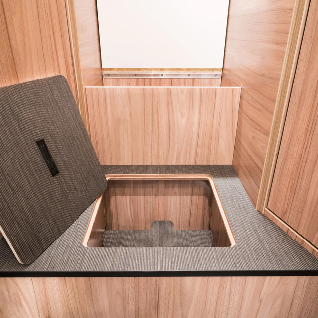 Open storage compartment in the stairs to the sleeping area in the rear of the HYMER Exsis