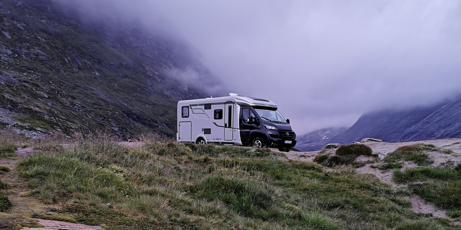 HYMER Exsis-t 580 in a stony mountain landscape in the clouds