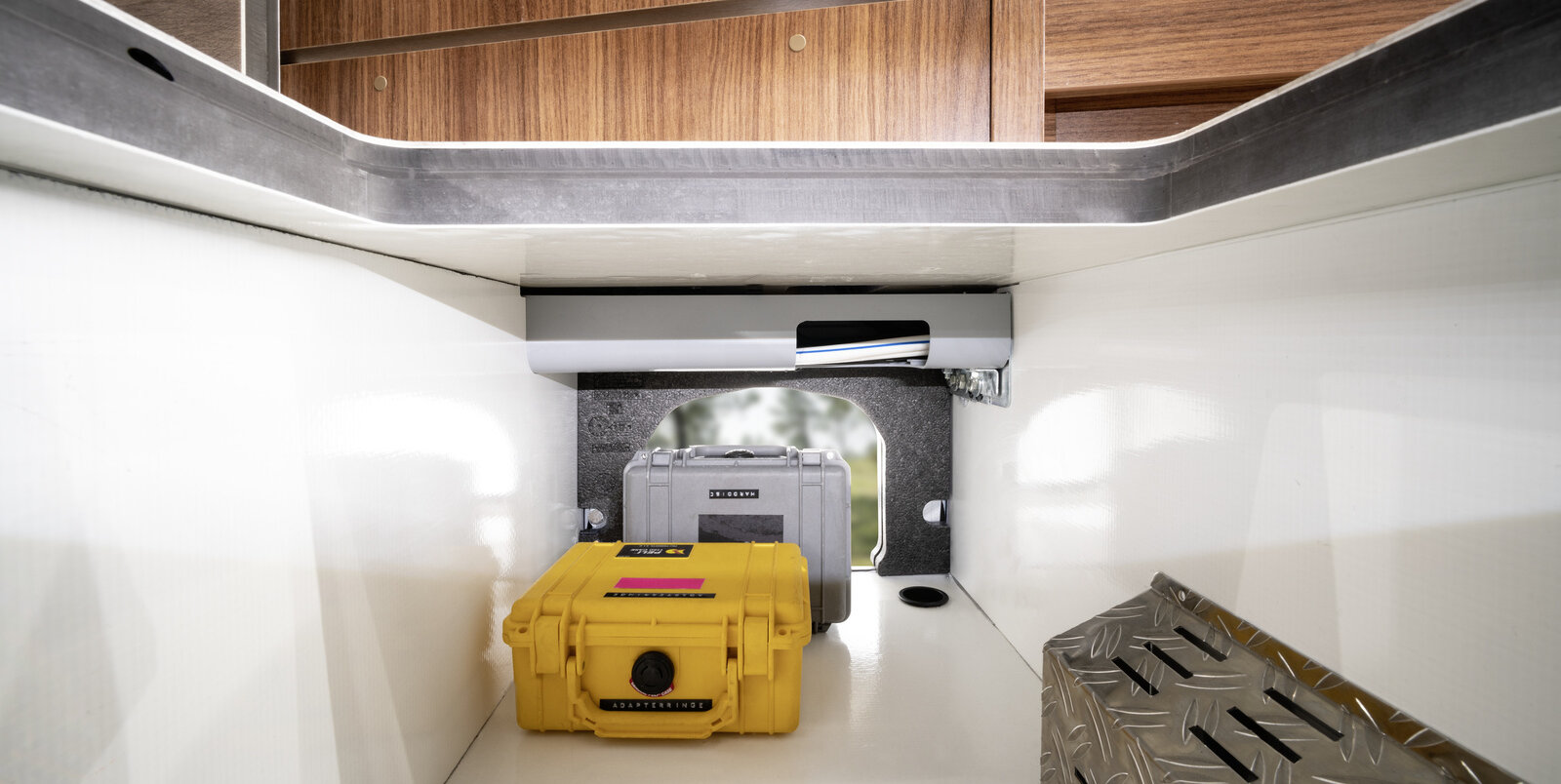 Loading compartment with yellow and gray boxes in the HYMER B-Class ModernComfort, which is open from the outside and from the living area
