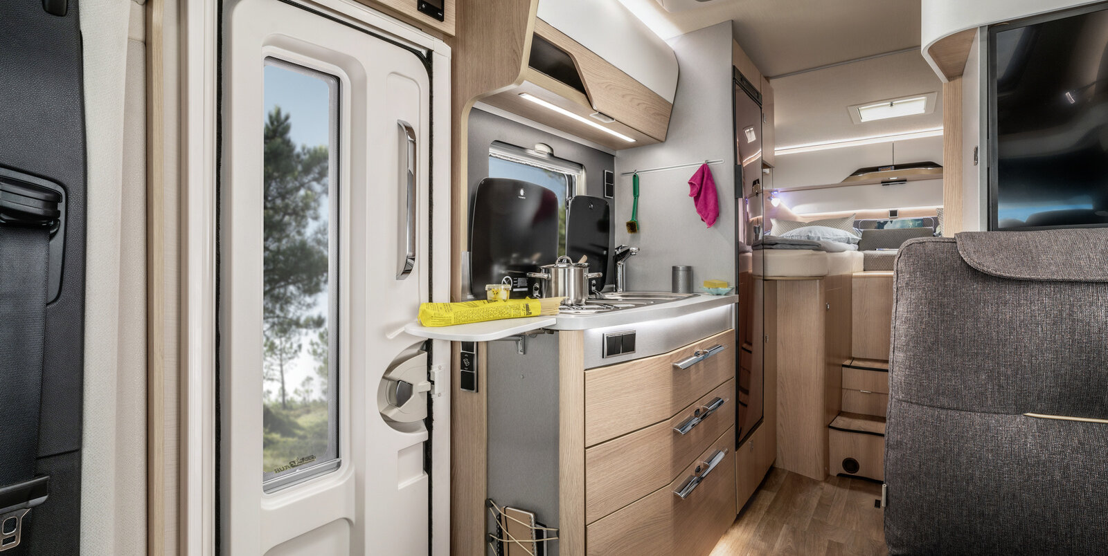 Kitchen block next to the entrance door with worktop extension and refrigerator in the HYMER B-MC