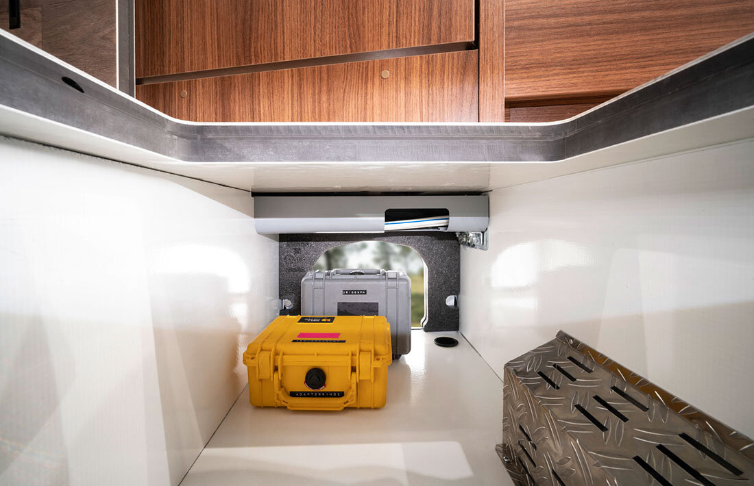 Loading compartment with yellow and gray boxes in the HYMER B-Class ModernComfort, which is open from the outside and from the living area
