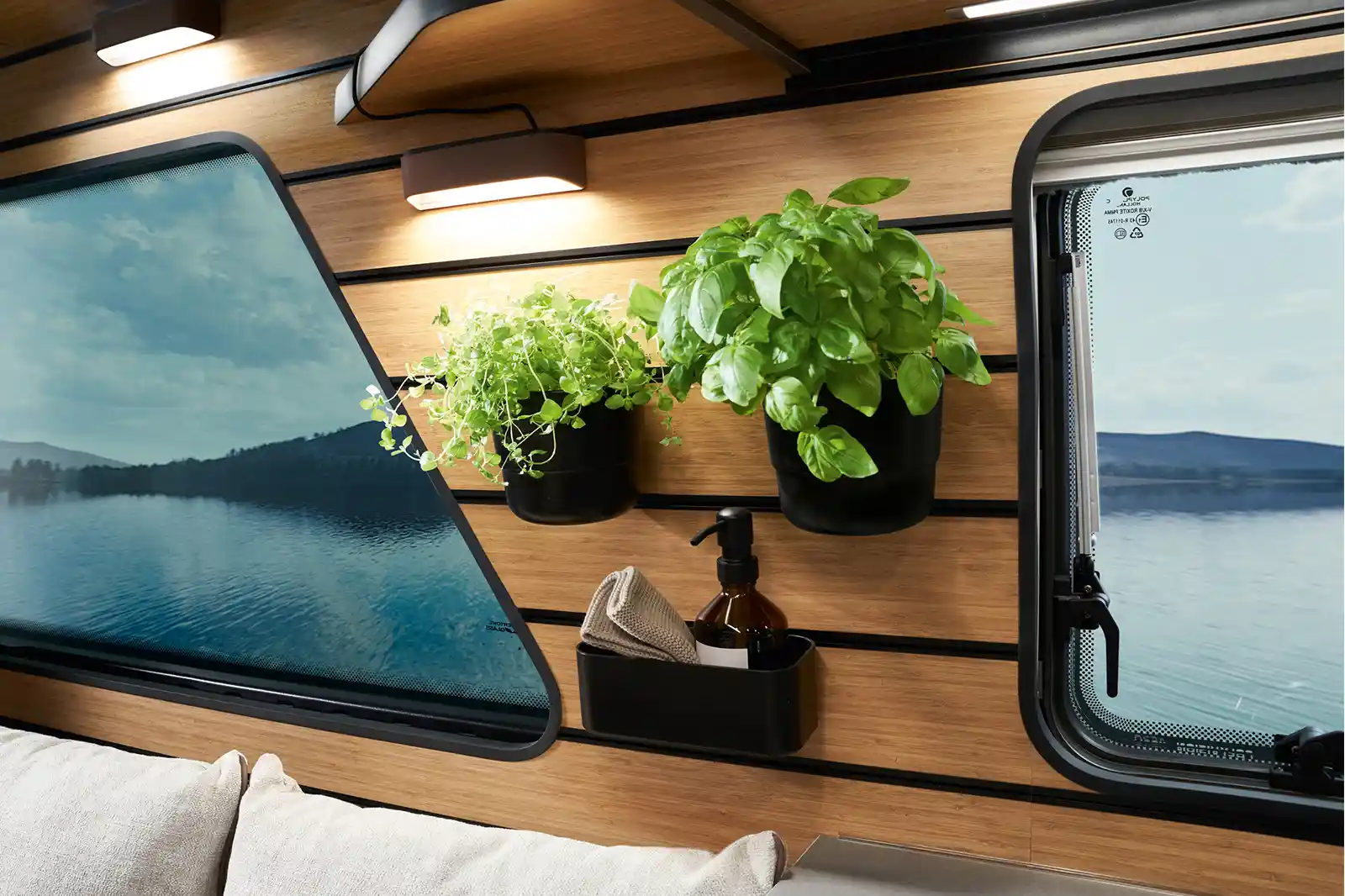 Two herb pots are mounted on the multifunction wall of the HYMER Venture S.