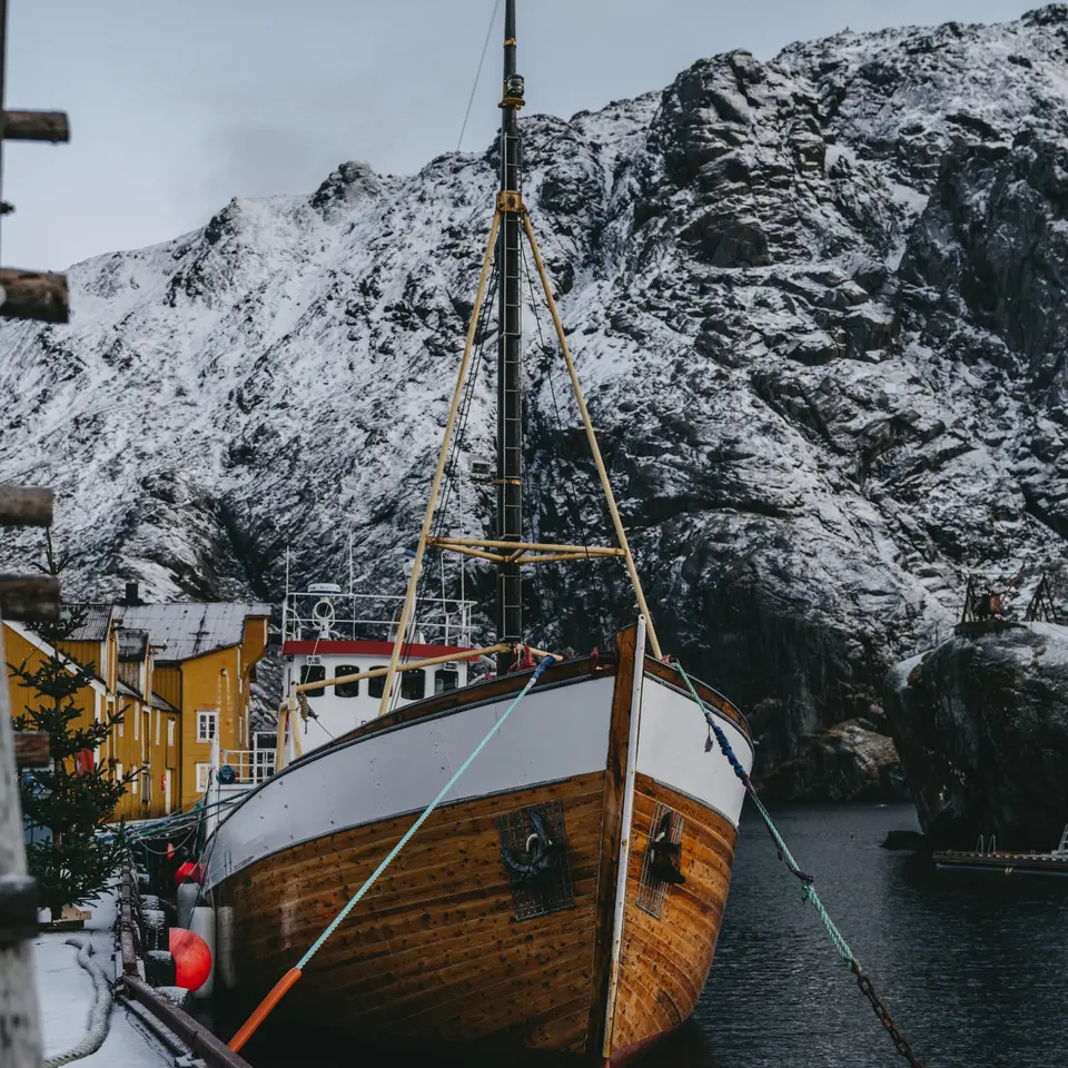 Boat moored, a large snow-covered mountain in the background