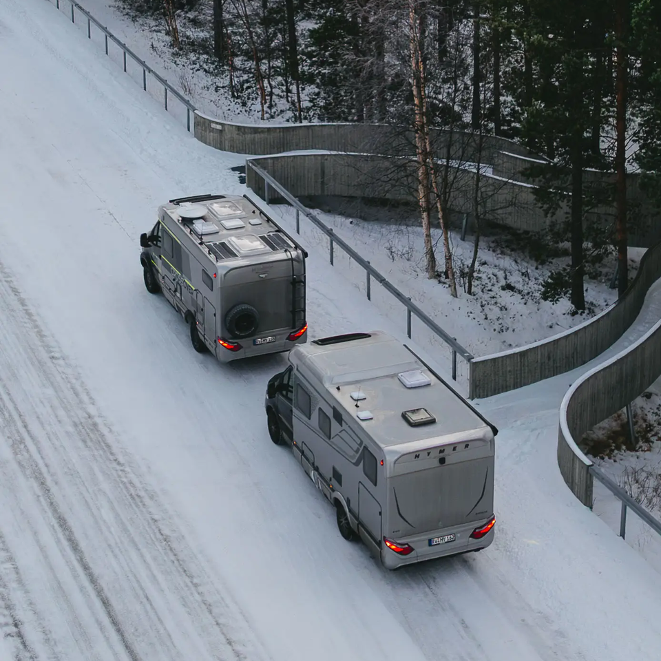 Aerial view of HYMER B-MC T BlackLine and HYMER ML-T 570 CrossOver, parked on a snowy road